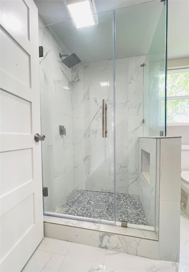2222 Peppermill Rd, Houston, TX 77080 - bathroom featuring marble look tiles, a marble finish shower, and toilet