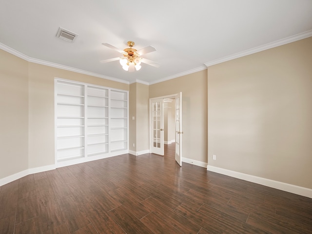 spare room with built in shelves, dark hardwood / wood-style flooring, ceiling fan, and crown molding