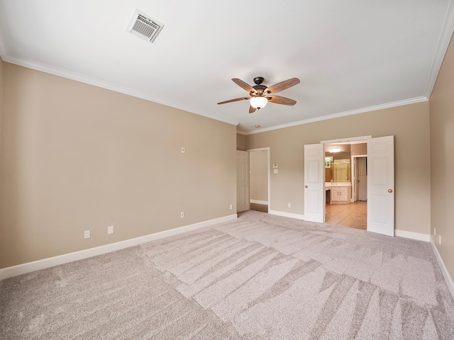 spare room featuring light carpet, crown molding, and ceiling fan