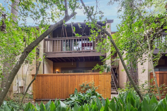 11711 Memorial Dr Unit 291, Houston, TX 77024 - back of house with stairs, stucco siding, a balcony, and fence