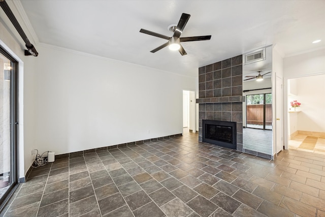 unfurnished living room featuring a tile fireplace, ceiling fan, and ornamental molding