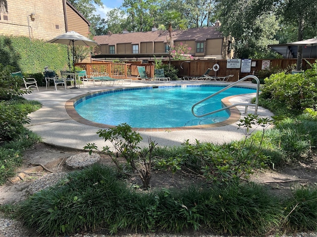 view of swimming pool with a patio