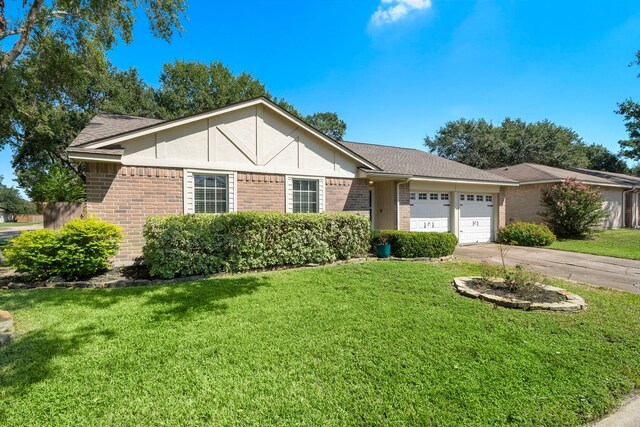 ranch-style house featuring a front lawn and a garage