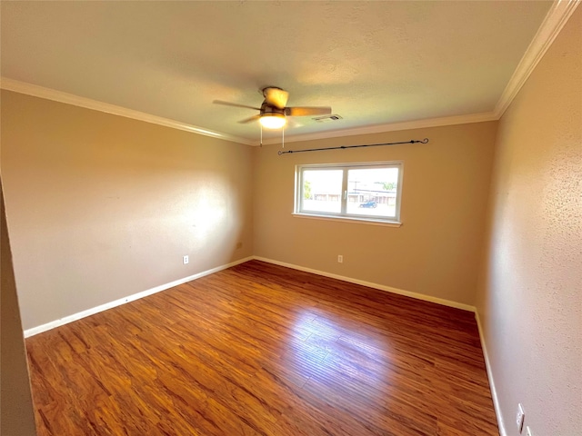 spare room featuring hardwood / wood-style floors, ceiling fan, and ornamental molding