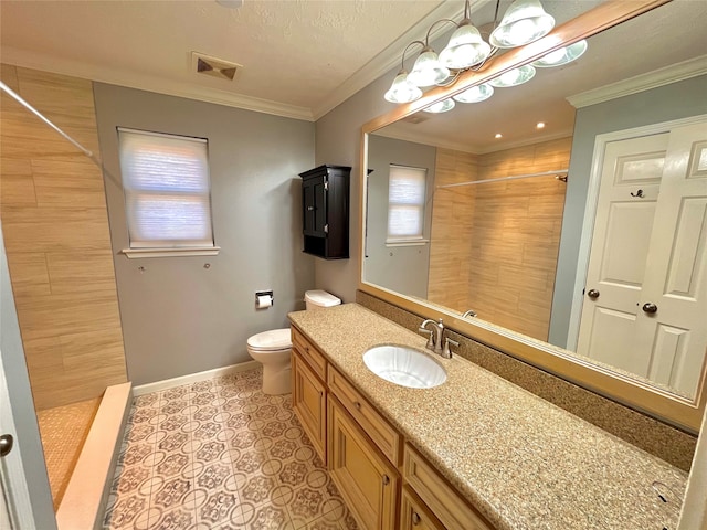 bathroom featuring vanity, toilet, ornamental molding, and a tile shower