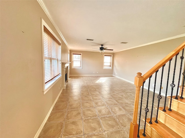 tiled spare room featuring crown molding and ceiling fan