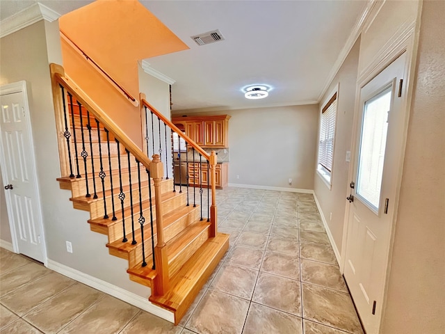 tiled entrance foyer featuring ornamental molding