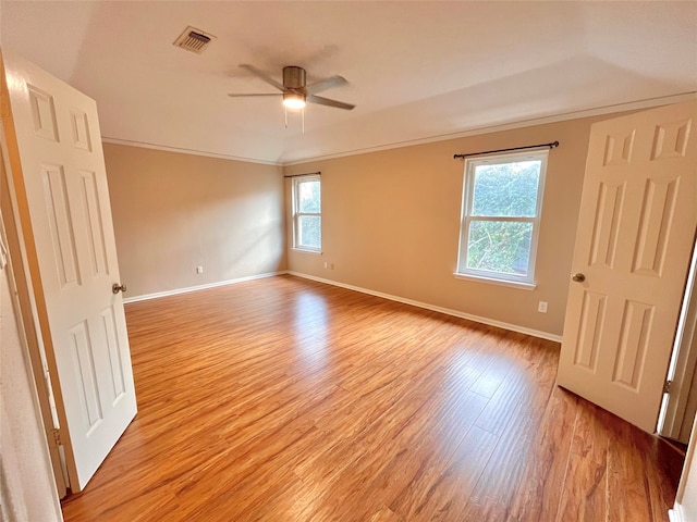 spare room with ceiling fan, light hardwood / wood-style floors, and ornamental molding