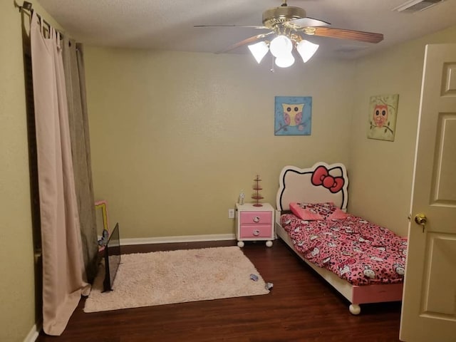 bedroom with ceiling fan and dark wood-type flooring