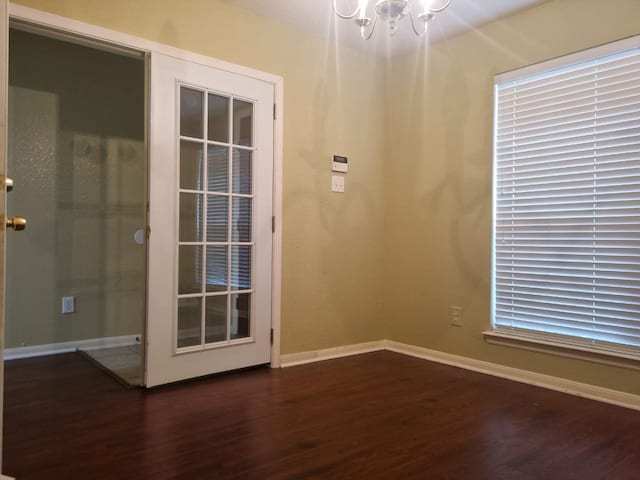 entryway featuring dark hardwood / wood-style flooring and a chandelier