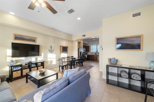 tiled living room featuring ceiling fan and a healthy amount of sunlight