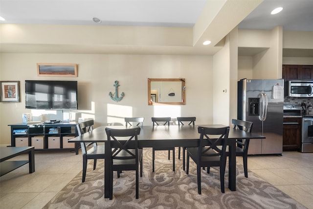 dining space featuring light tile patterned floors and a healthy amount of sunlight