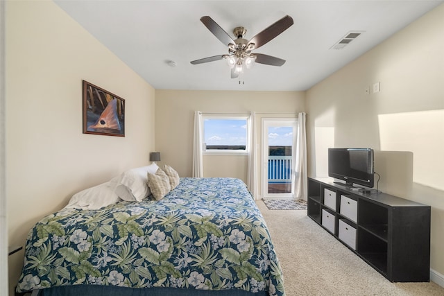 bedroom with light carpet, access to exterior, and ceiling fan