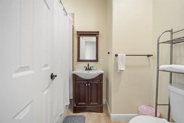 bathroom featuring vanity and toilet