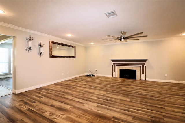 unfurnished living room featuring ceiling fan, dark hardwood / wood-style flooring, ornamental molding, and a fireplace