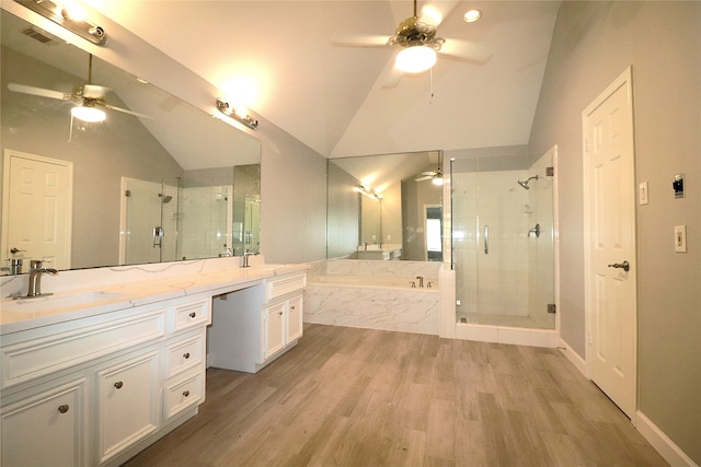 bathroom featuring vanity, vaulted ceiling, ceiling fan, hardwood / wood-style flooring, and shower with separate bathtub