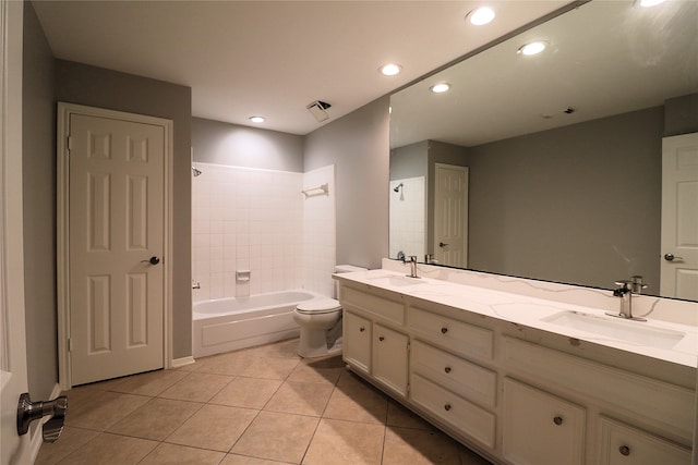 full bathroom with tile patterned flooring, vanity, toilet, and tiled shower / bath