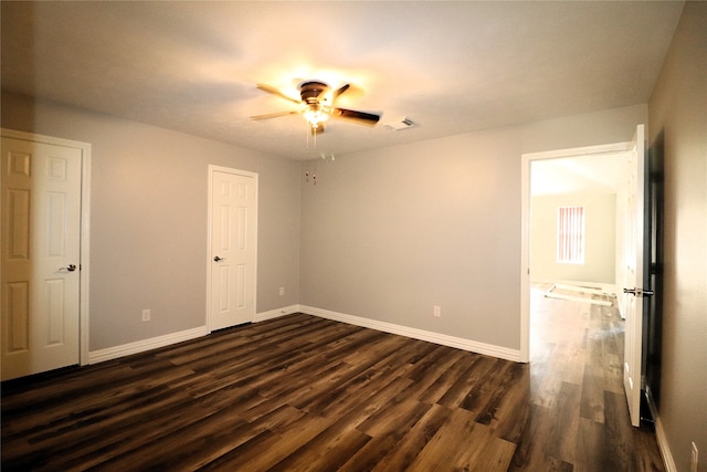 unfurnished room featuring ceiling fan and dark hardwood / wood-style floors