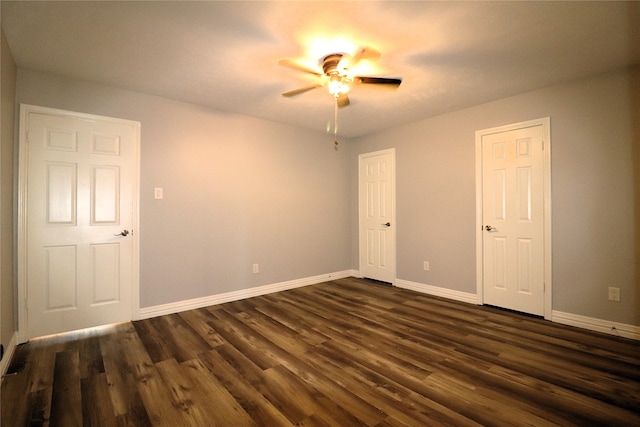 spare room with ceiling fan and dark wood-type flooring