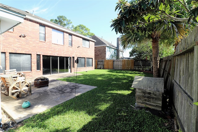 view of yard featuring a patio and an outdoor fire pit