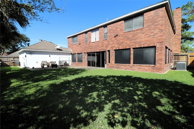 2304 Eagles Way, Pearland, TX 77581 - rear view of house featuring central air condition unit, brick siding, a chimney, and a patio area