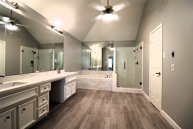 bathroom featuring vanity, hardwood / wood-style floors, plus walk in shower, and vaulted ceiling