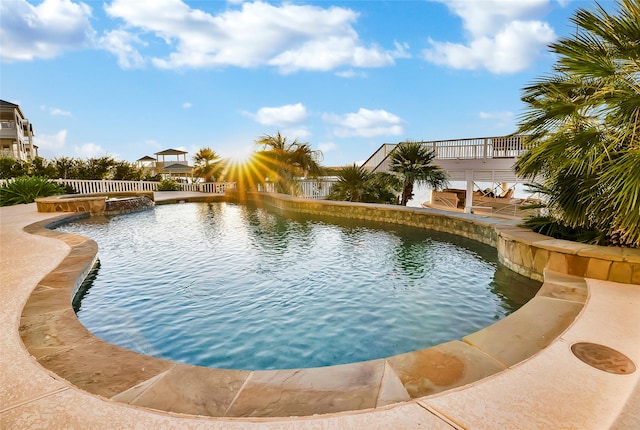 view of swimming pool featuring an in ground hot tub and a deck