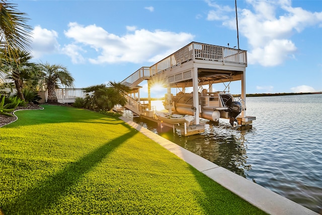 view of dock with a yard and a water view