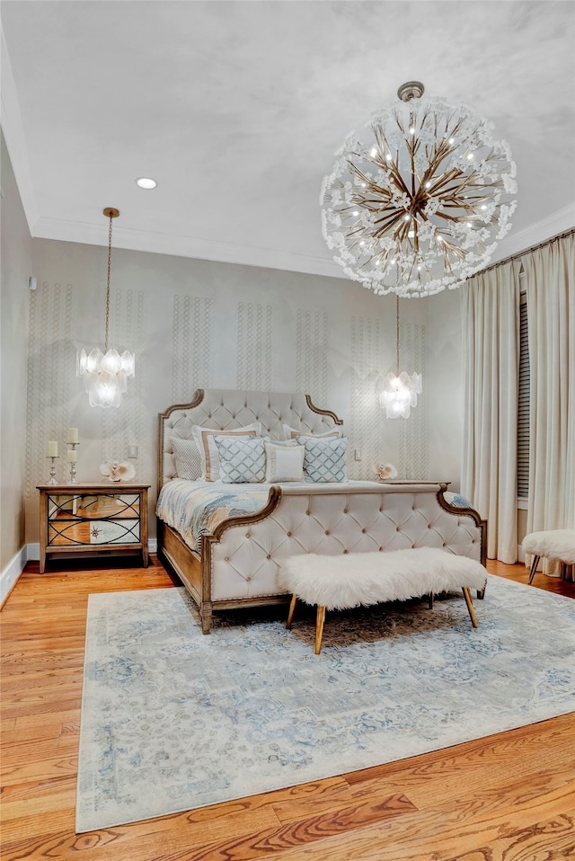 unfurnished bedroom with hardwood / wood-style flooring, ornamental molding, and a chandelier