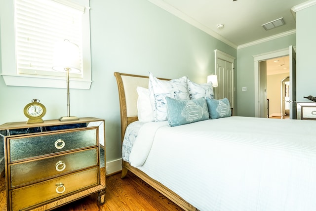 bedroom with ornamental molding and dark wood-type flooring