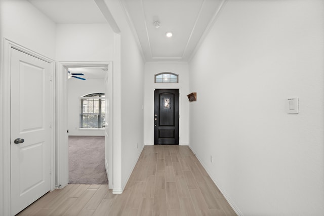 interior space with ornamental molding and light carpet