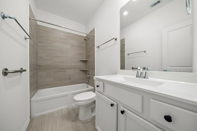 full bathroom featuring vanity, toilet, and tiled shower / bath