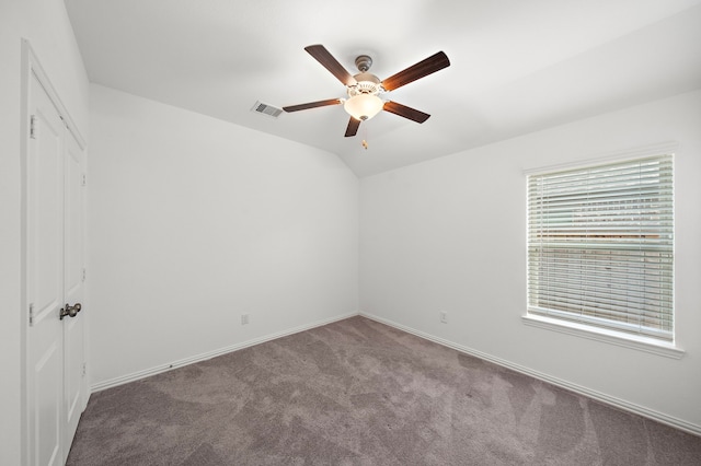 unfurnished room featuring ceiling fan, carpet floors, and vaulted ceiling