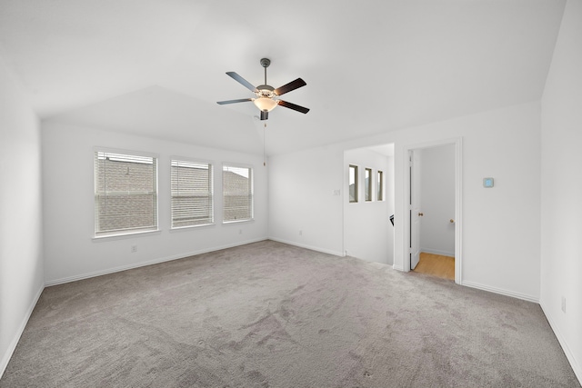 unfurnished room featuring ceiling fan, light colored carpet, and lofted ceiling