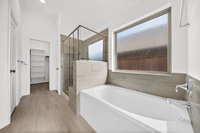 bathroom with separate shower and tub and crown molding