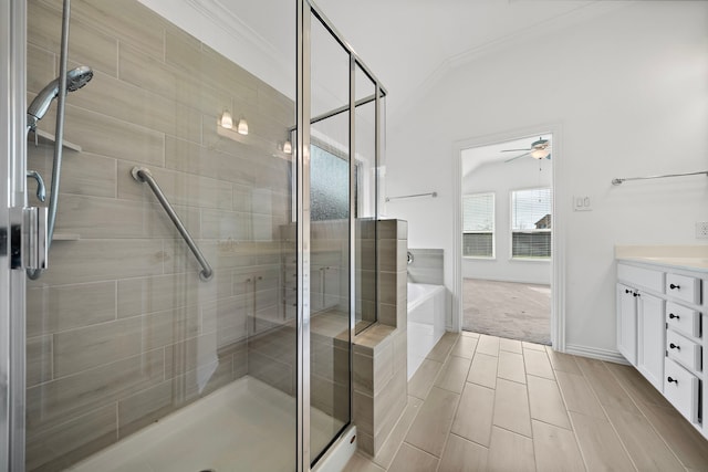 bathroom featuring ceiling fan, vanity, independent shower and bath, and vaulted ceiling