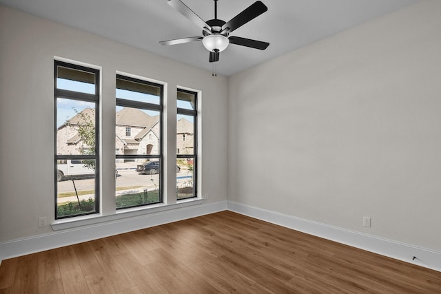 unfurnished room with hardwood / wood-style floors and ceiling fan