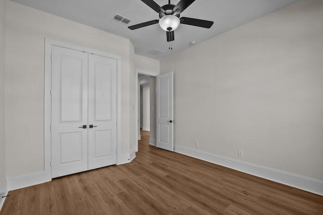 unfurnished bedroom with a closet, ceiling fan, and light wood-type flooring