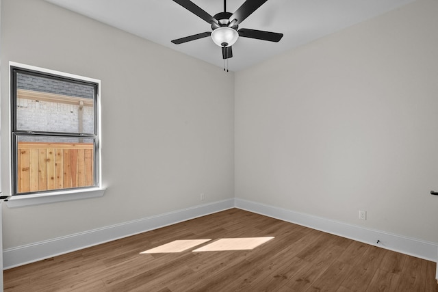 spare room with ceiling fan and wood-type flooring