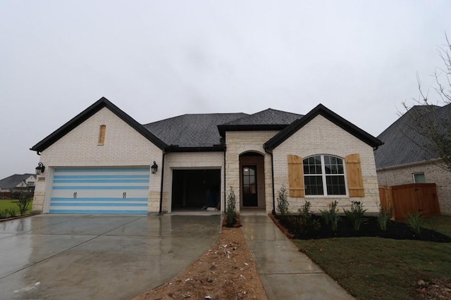 french country inspired facade featuring a garage