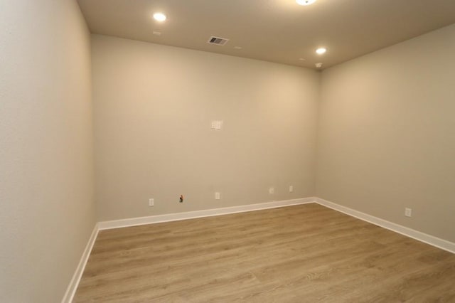 empty room with hardwood / wood-style flooring