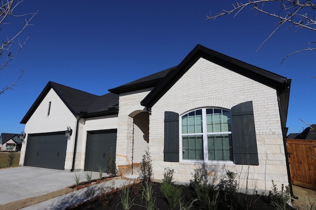 french country inspired facade with a garage