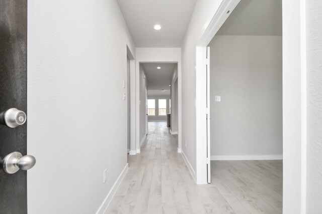 corridor with light wood-type flooring