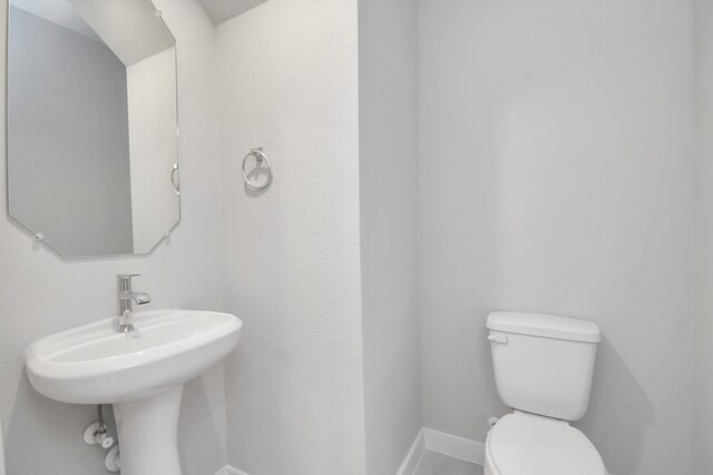 bathroom featuring sink and toilet