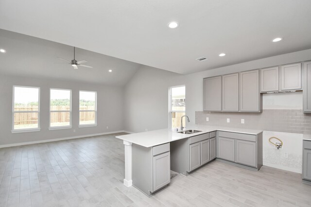 kitchen featuring gray cabinets, sink, and a wealth of natural light