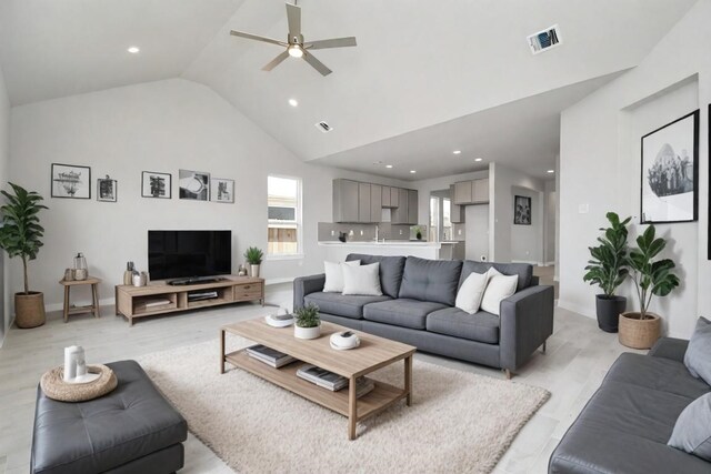 living room with high vaulted ceiling, light hardwood / wood-style flooring, and ceiling fan