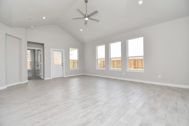 unfurnished room featuring light hardwood / wood-style floors, high vaulted ceiling, and ceiling fan