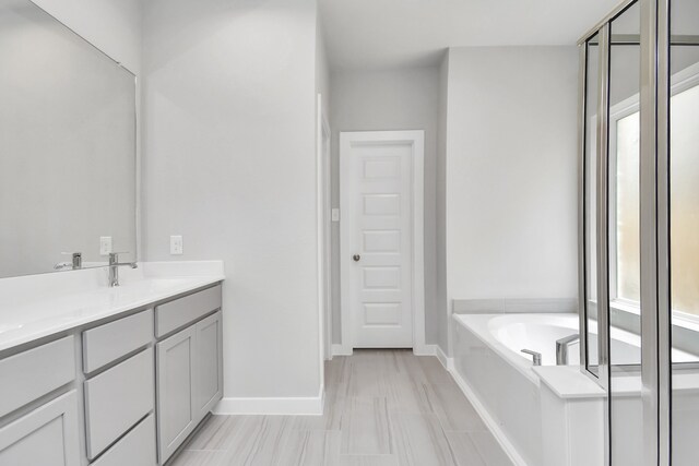 bathroom with vanity and a bath