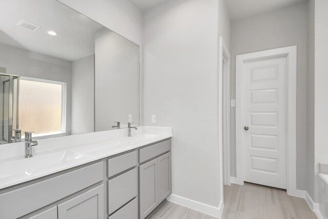 bathroom with hardwood / wood-style floors and vanity