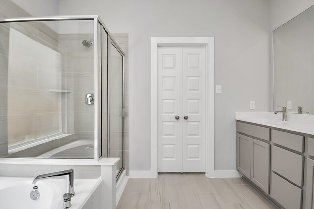 bathroom featuring plus walk in shower and vanity